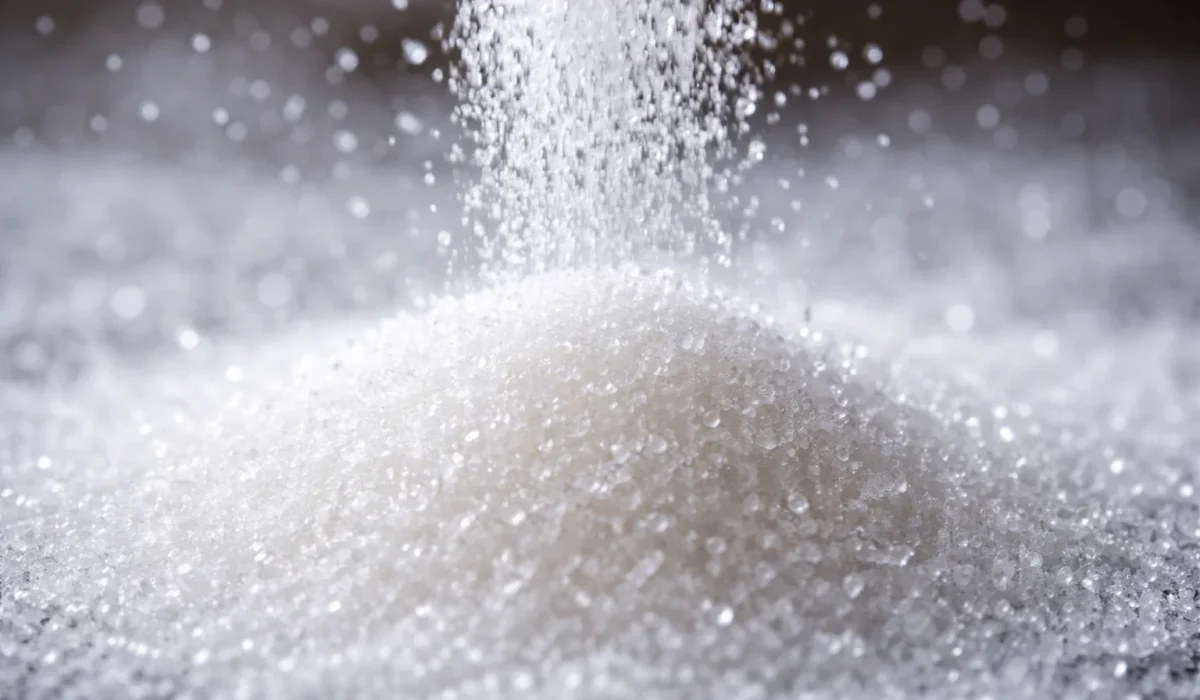 refined sugar pouring granulated sugar close up unhealthy sweet ingredient