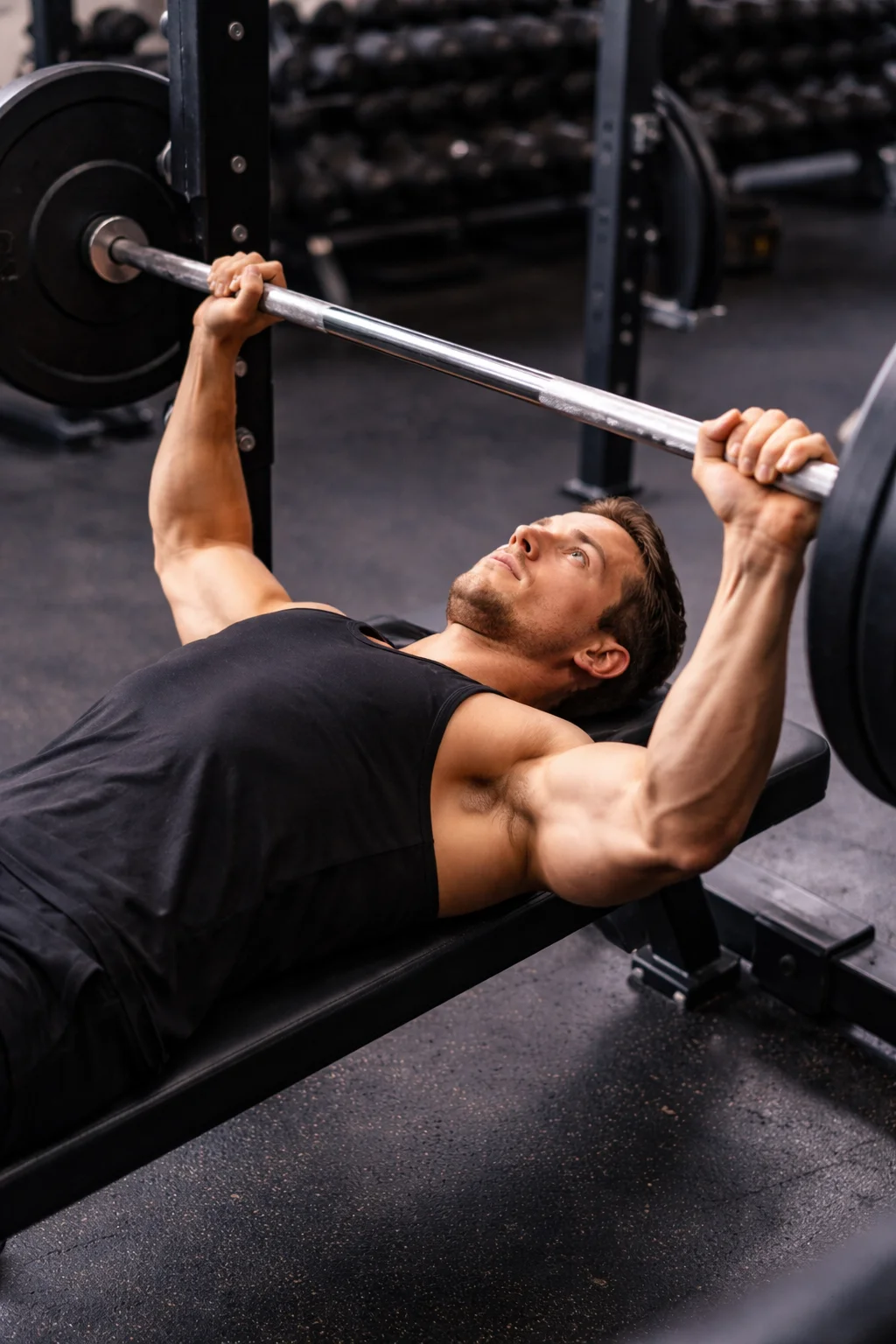 man performing bench press with barbell for strength training