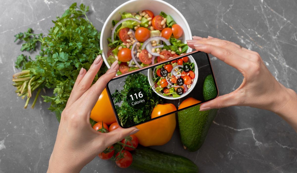 Female using dieting app on a smartphone to track nutrition facts