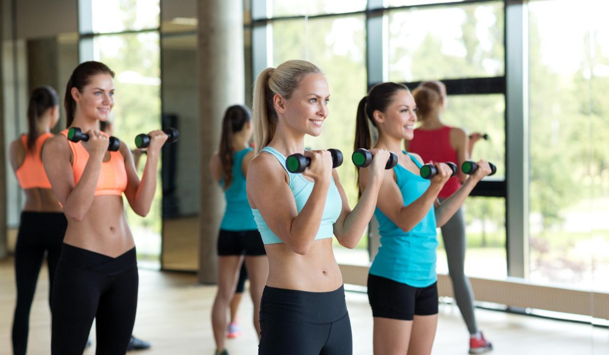 Fitness, sport, training, gym and lifestyle concept - group of women