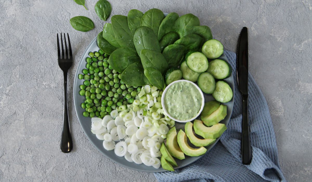 Fresh green salad on gray stone table