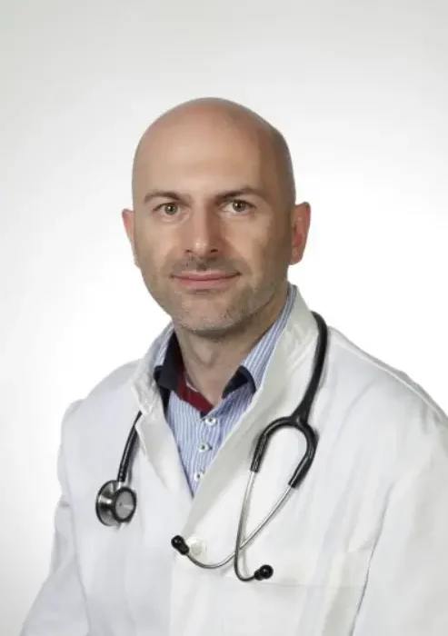 Dr. Ioannis Nikitidis, Medical Doctor and Registered Dietitian-Nutritionist with a stethoscope, who reviewed the IIFYM macro calculator for medical accuracy and safety